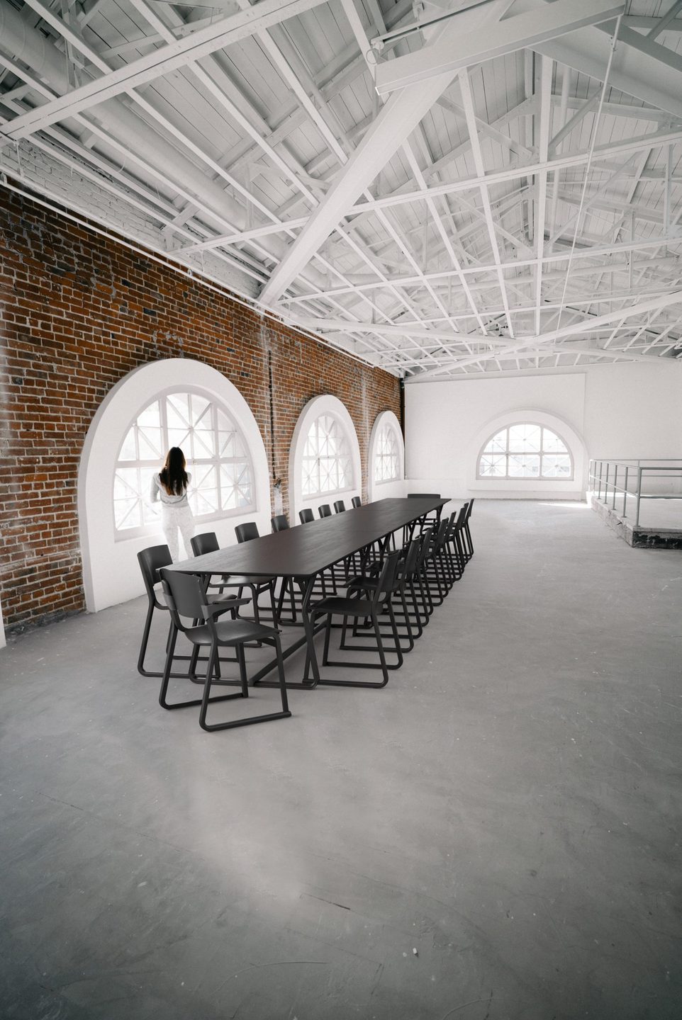 Large black stained conference table in open plan space
