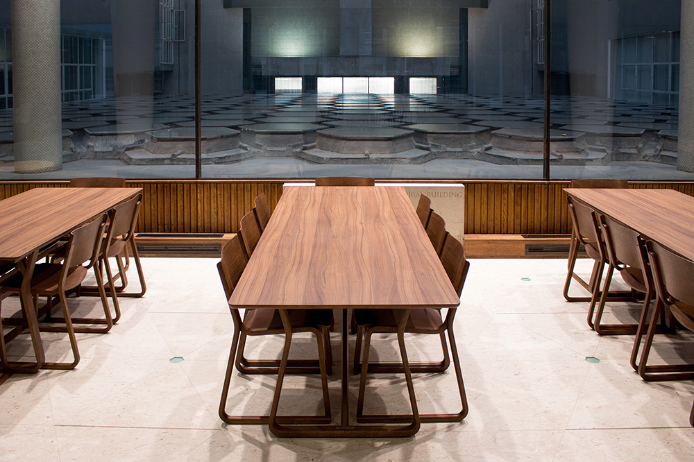 Walnut stained folding tables with matching chairs in canteen area